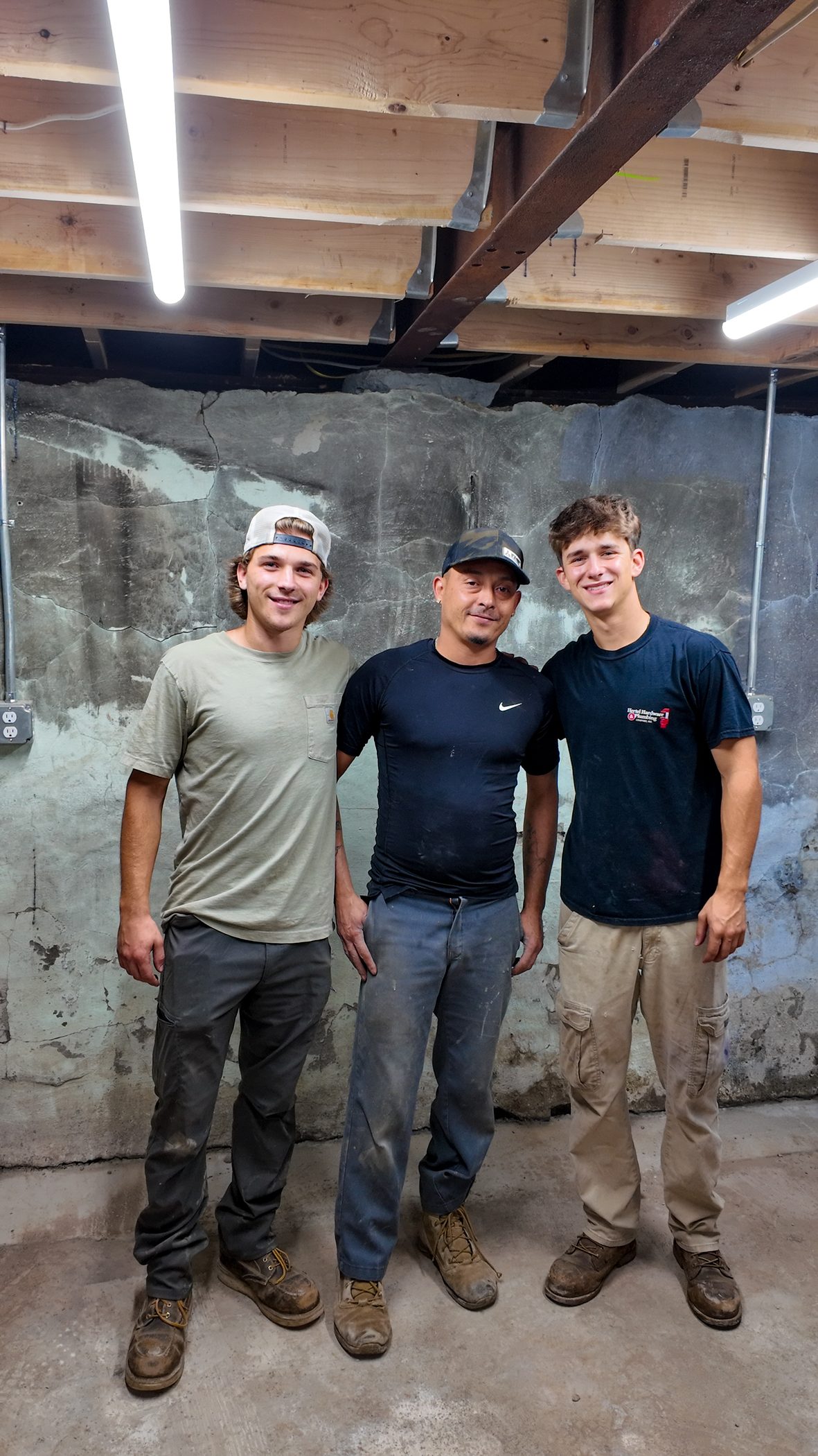 Three Hertel heating and cooling technicians on a job