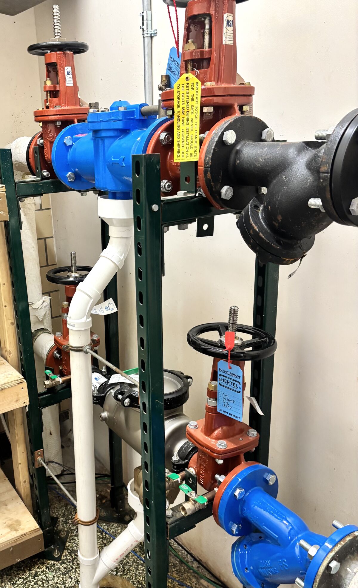 Backflow prevention assemblies with a Hertel inspection tag.