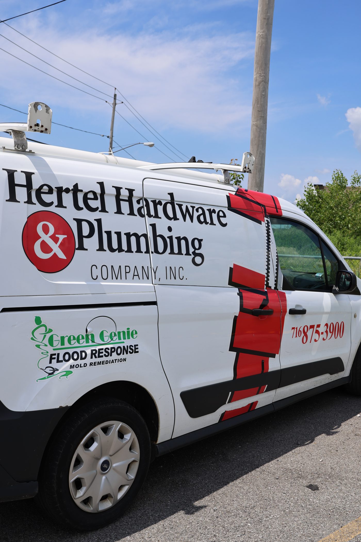 A Hertel service van with the phone number on the side