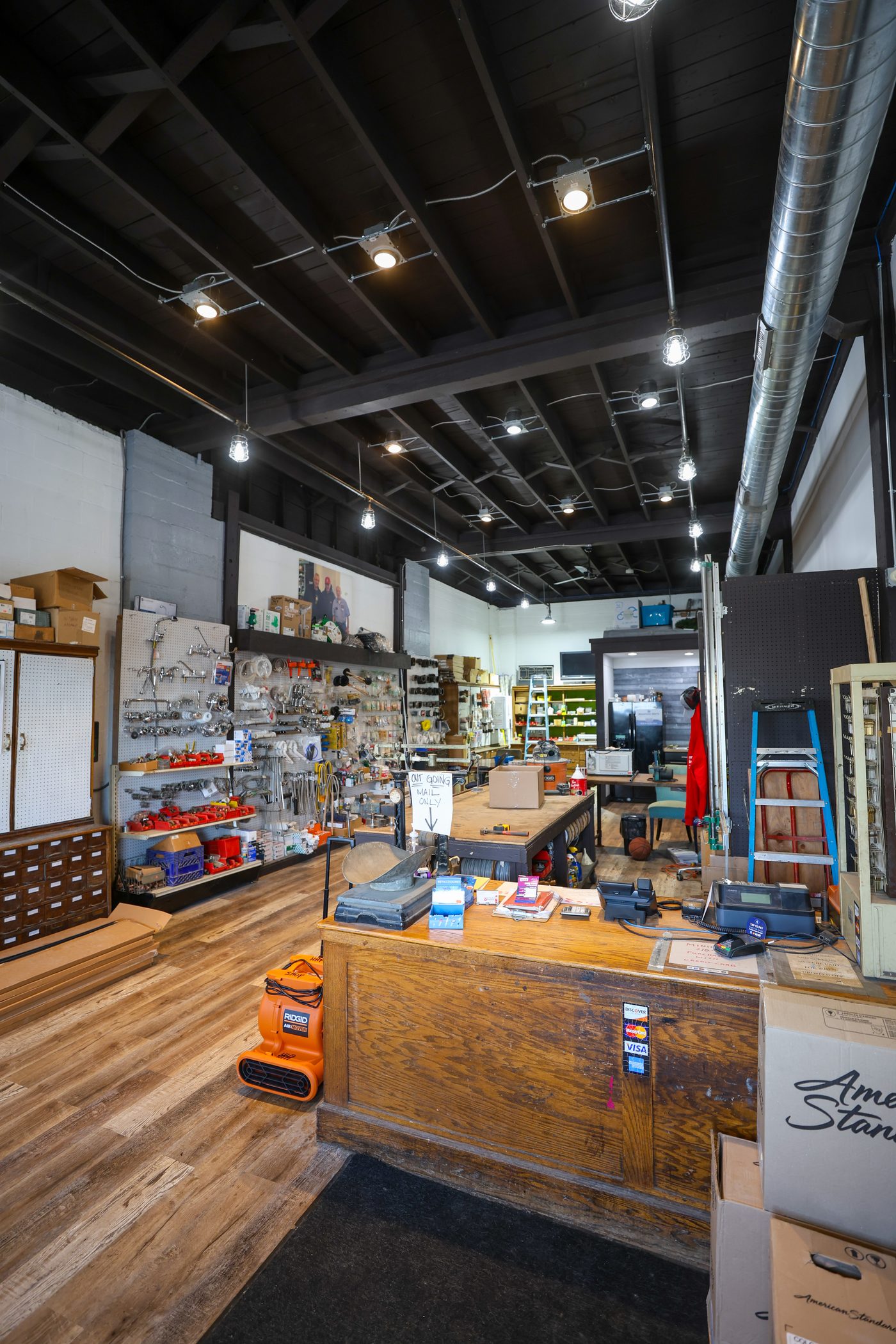 The wooden counter and register at the Hertel hardware shop